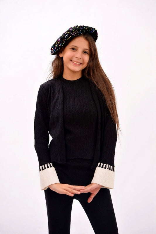 ribbed black top paired with a matching open-front cardigan