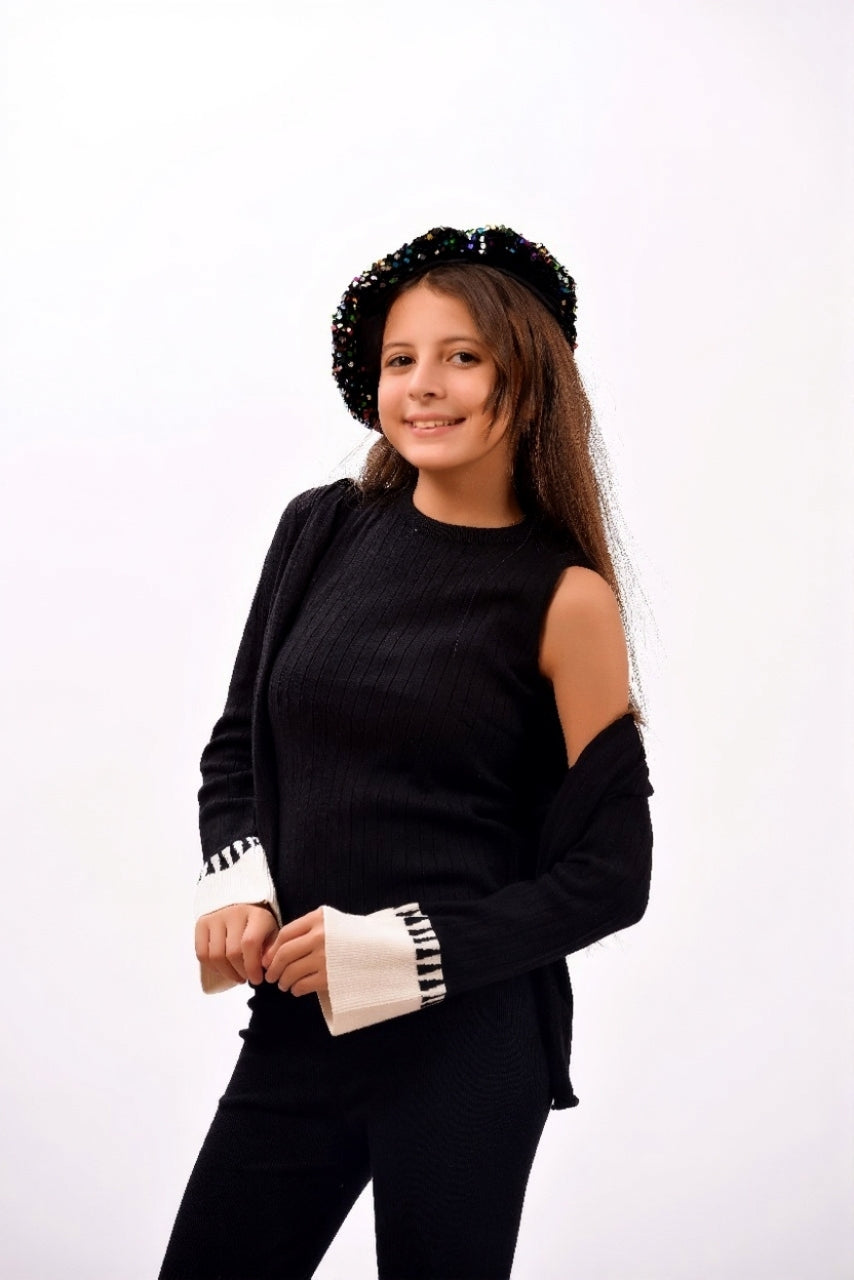 ribbed black top paired with a matching open-front cardigan